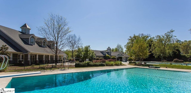 view of swimming pool with fence and a fenced in pool