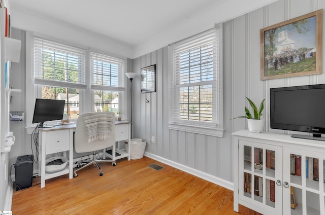 office with visible vents, a healthy amount of sunlight, and light wood-type flooring