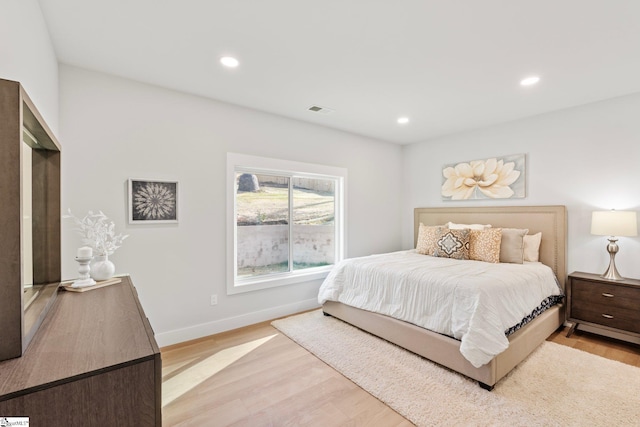 bedroom featuring baseboards, recessed lighting, light wood finished floors, and visible vents