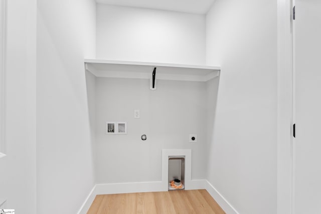 laundry room with laundry area, baseboards, light wood-type flooring, washer hookup, and hookup for an electric dryer
