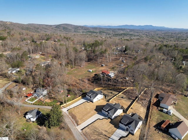 aerial view featuring a mountain view and a wooded view