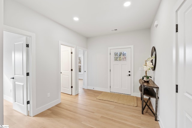 foyer with baseboards, recessed lighting, light wood-style flooring, and visible vents