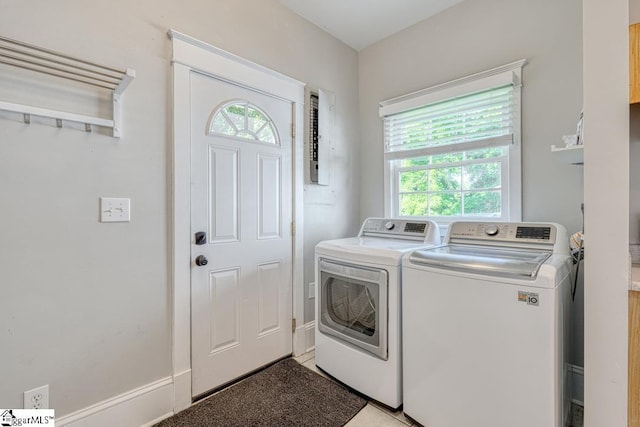 washroom featuring laundry area, washer and dryer, and a healthy amount of sunlight