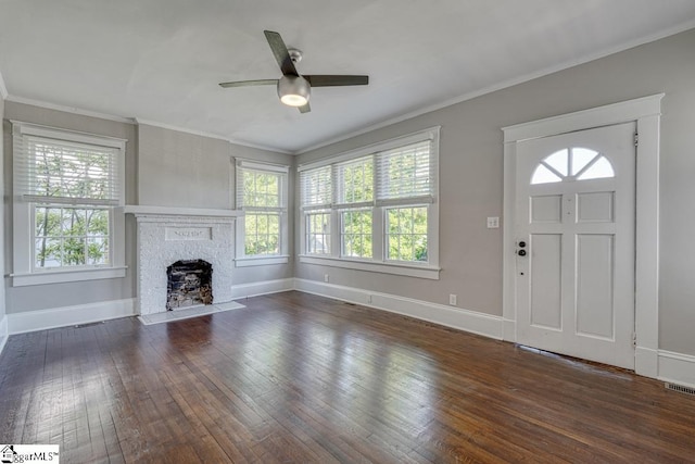 unfurnished living room with wood-type flooring, a ceiling fan, crown molding, and a wealth of natural light