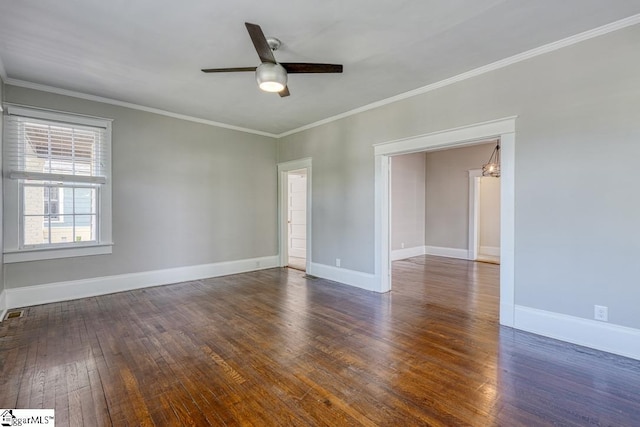 empty room with crown molding, baseboards, a ceiling fan, and wood finished floors