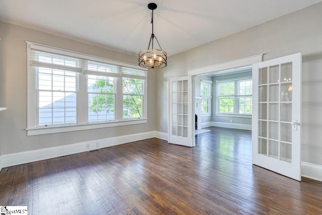 unfurnished dining area featuring dark wood-style flooring and a healthy amount of sunlight