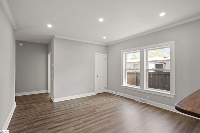 unfurnished living room with crown molding, visible vents, and dark wood-style floors