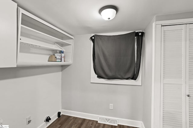 washroom featuring baseboards, laundry area, visible vents, and dark wood finished floors
