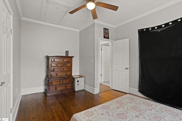 bedroom with baseboards, ornamental molding, wood finished floors, and attic access
