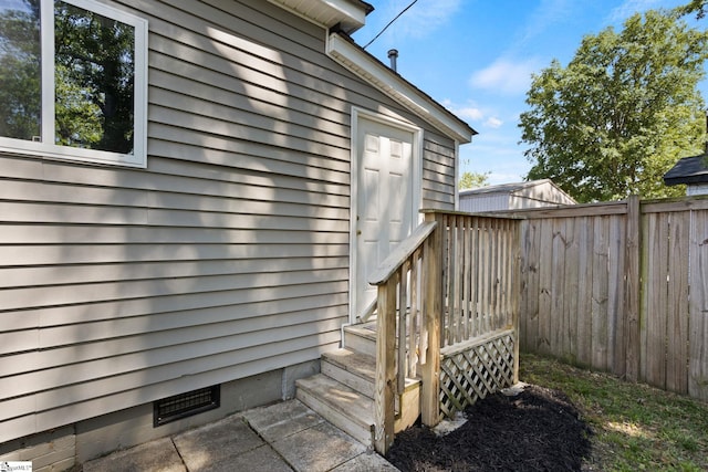 exterior space featuring fence and crawl space