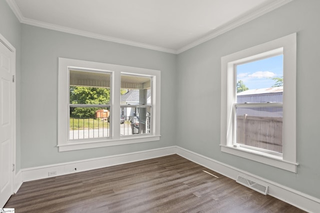 unfurnished room with visible vents, ornamental molding, dark wood-style flooring, and baseboards