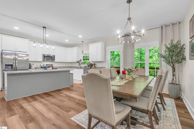 dining area featuring an inviting chandelier, recessed lighting, and light wood-style flooring
