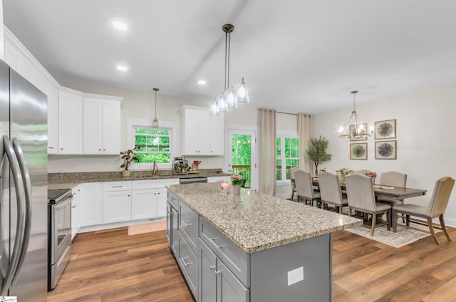 kitchen with appliances with stainless steel finishes, plenty of natural light, gray cabinets, and recessed lighting