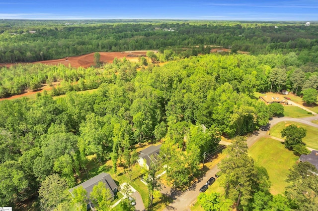 birds eye view of property with a forest view