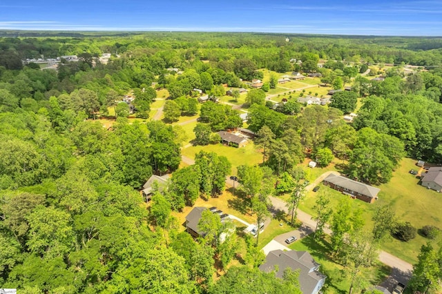 birds eye view of property with a residential view and a wooded view