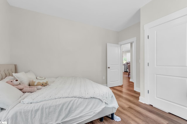bedroom featuring light wood-style floors and baseboards