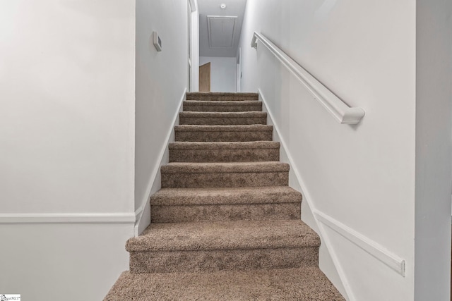 stairway featuring attic access