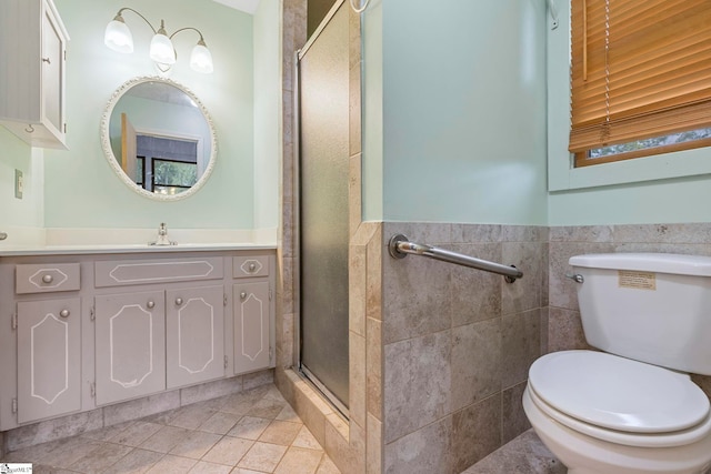 full bath featuring vanity, tile patterned flooring, toilet, tile walls, and a shower stall