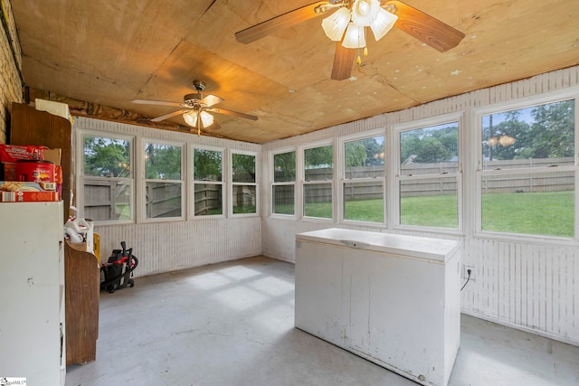 unfurnished sunroom with ceiling fan and a wealth of natural light