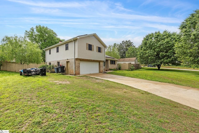 view of front facade with a front yard, brick siding, fence, concrete driveway, and an attached garage