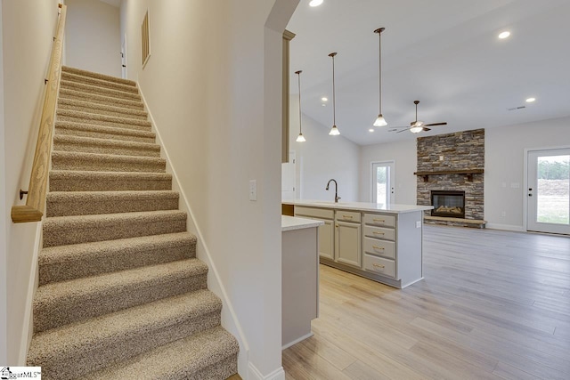 108 Walters Way, Pickens, SC 29671 - stairway with a ceiling fan, wood finished floors, a stone fireplace, arched walkways, and recessed lighting