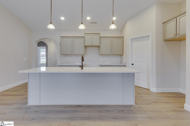 108 Walters Way, Pickens, SC 29671 - kitchen featuring a sink, arched walkways, baseboards, a kitchen island with sink, and lofted ceiling