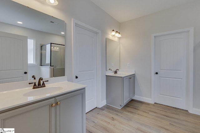 108 Walters Way, Pickens, SC 29671 - full bathroom featuring wood finished floors, two vanities, a stall shower, and baseboards