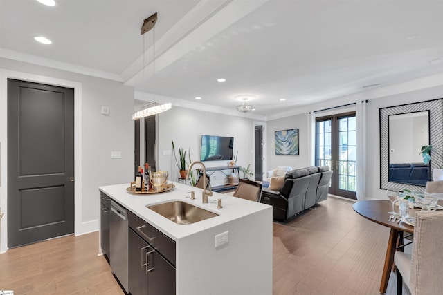 kitchen with a sink, dishwasher, open floor plan, and light countertops