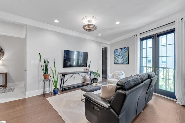 living area featuring recessed lighting, french doors, a wealth of natural light, and wood finished floors
