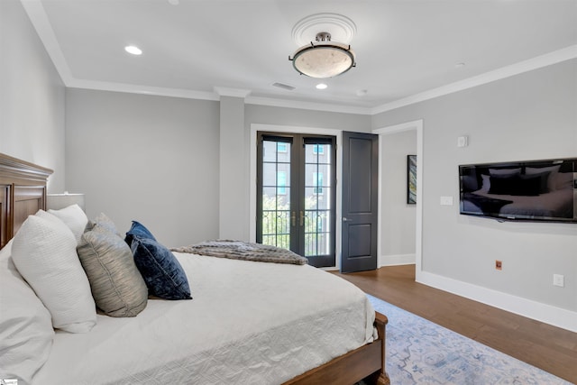 bedroom featuring french doors, visible vents, crown molding, wood finished floors, and baseboards