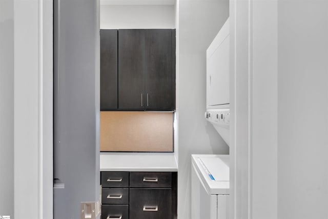 washroom with stacked washer and dryer