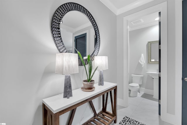 corridor featuring baseboards, visible vents, and marble finish floor