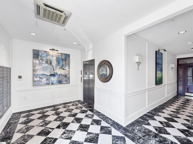 interior space featuring recessed lighting, a decorative wall, and elevator