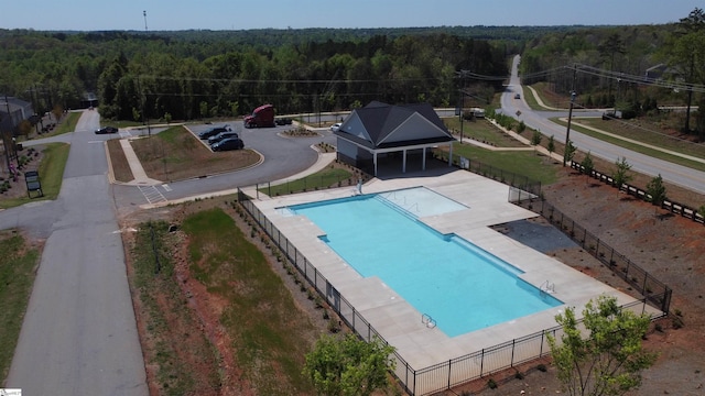 pool with a forest view and fence