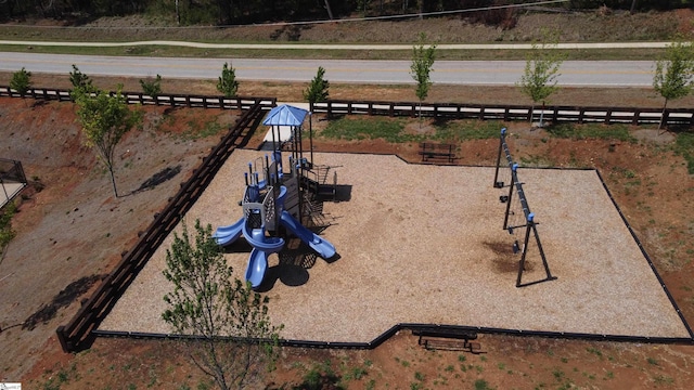view of property's community with fence and playground community