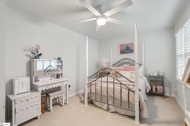 bedroom featuring baseboards, ceiling fan, and light carpet