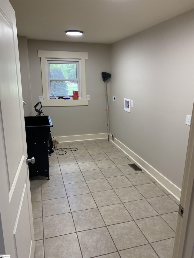 laundry area with light tile patterned flooring, laundry area, hookup for a washing machine, hookup for an electric dryer, and visible vents