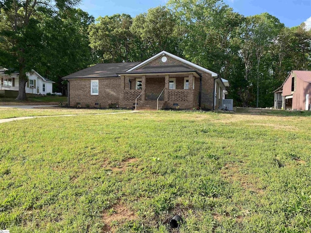 single story home with a porch, crawl space, a front yard, and brick siding
