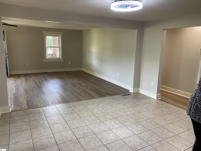 unfurnished room featuring baseboards and wood finished floors