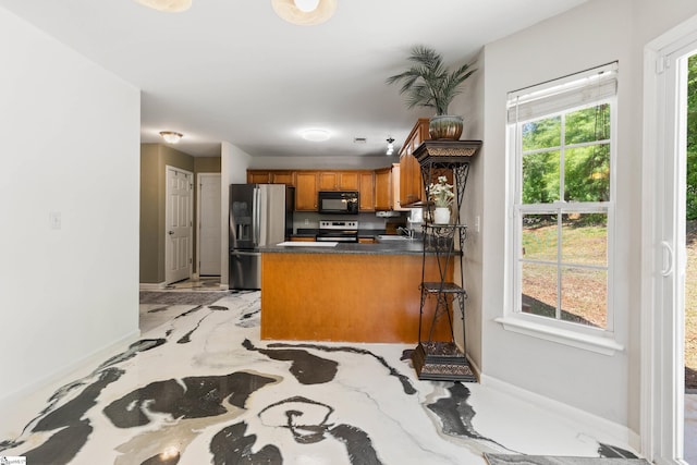 2 Susana Dr, Greer, SC 29651 - kitchen with appliances with stainless steel finishes, dark countertops, brown cabinets, baseboards, and a peninsula