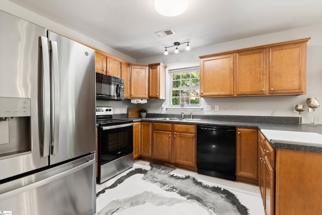 2 Susana Dr, Greer, SC 29651 - kitchen with brown cabinets, dark countertops, a sink, visible vents, and black appliances