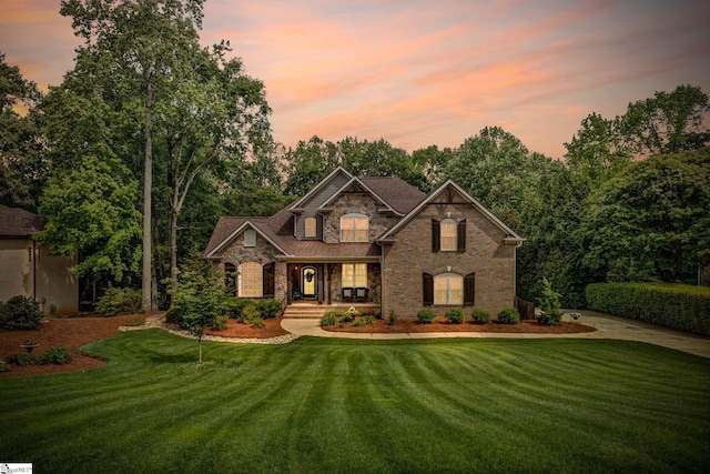 17 Avens Hill Dr, Greer, SC 29651 - craftsman-style house with covered porch, stone siding, brick siding, concrete driveway, and a lawn