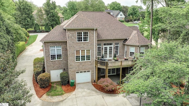17 Avens Hill Dr, Greer, SC 29651 - rear view of house with french doors, brick siding, concrete driveway, an attached garage, and a shingled roof