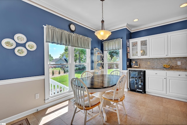 105 Chariot Ln, Simpsonville, SC 29681 - dining room featuring light tile patterned floors, baseboards, wine cooler, bar area, and ornamental molding
