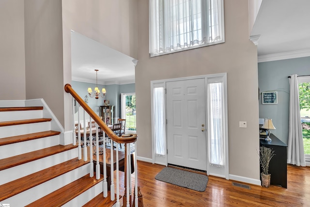 105 Chariot Ln, Simpsonville, SC 29681 - foyer entrance with an inviting chandelier, crown molding, stairs, visible vents, and wood finished floors