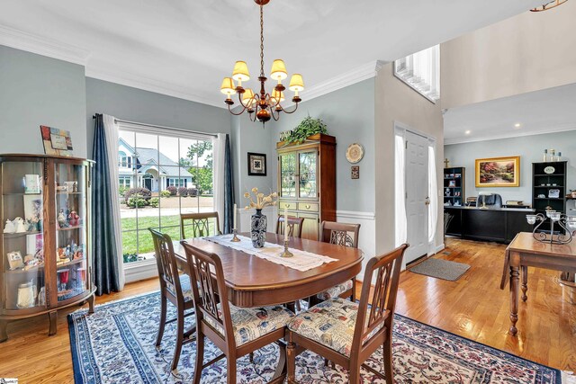 105 Chariot Ln, Simpsonville, SC 29681 - dining area featuring crown molding, light wood finished floors, and a notable chandelier