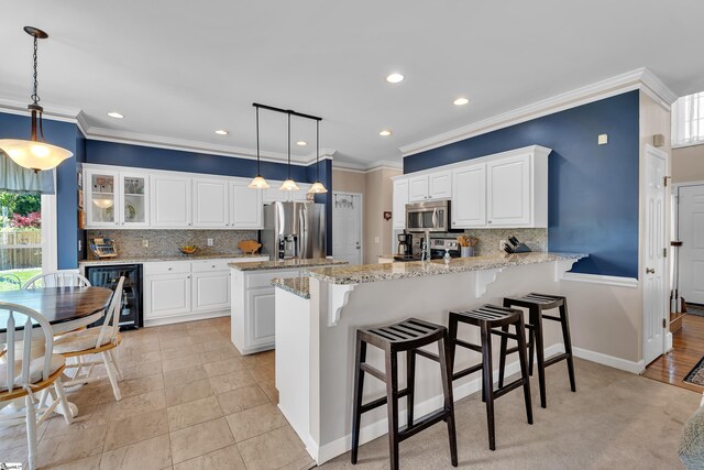 105 Chariot Ln, Simpsonville, SC 29681 - kitchen featuring decorative backsplash, a peninsula, wine cooler, recessed lighting, and stainless steel appliances
