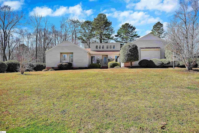 traditional home with an attached garage and a front yard