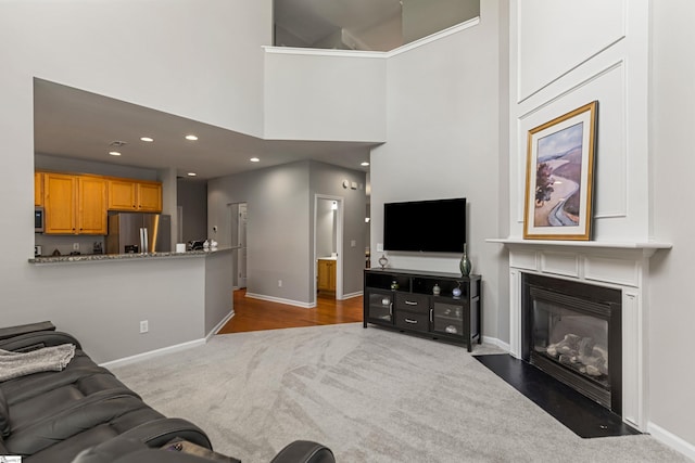 502 Kingsmoor Dr, Simpsonville, SC 29681 - living area with carpet floors, baseboards, a high ceiling, recessed lighting, and a fireplace with flush hearth