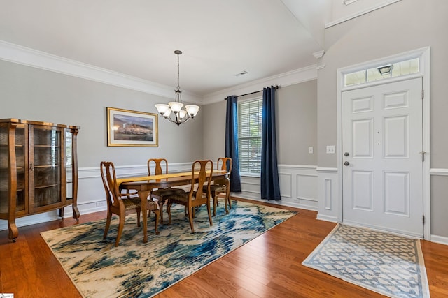502 Kingsmoor Dr, Simpsonville, SC 29681 - dining room featuring an inviting chandelier, a wainscoted wall, wood finished floors, and visible vents